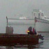 Several boats sitting in the water on a hazy afternoon in Maine.